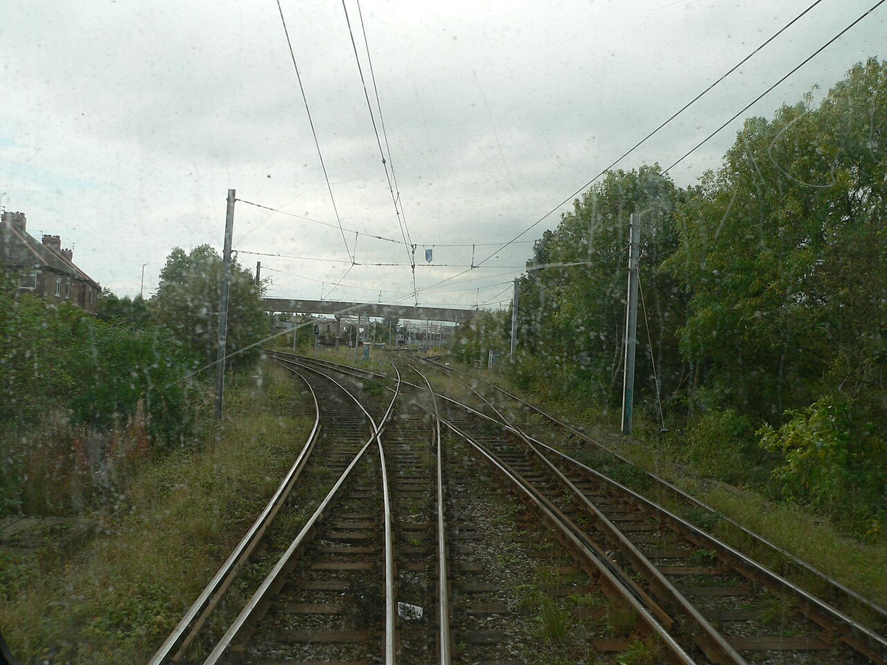 Symmetrical railway junction tracks overhead representing bidirectional routing.