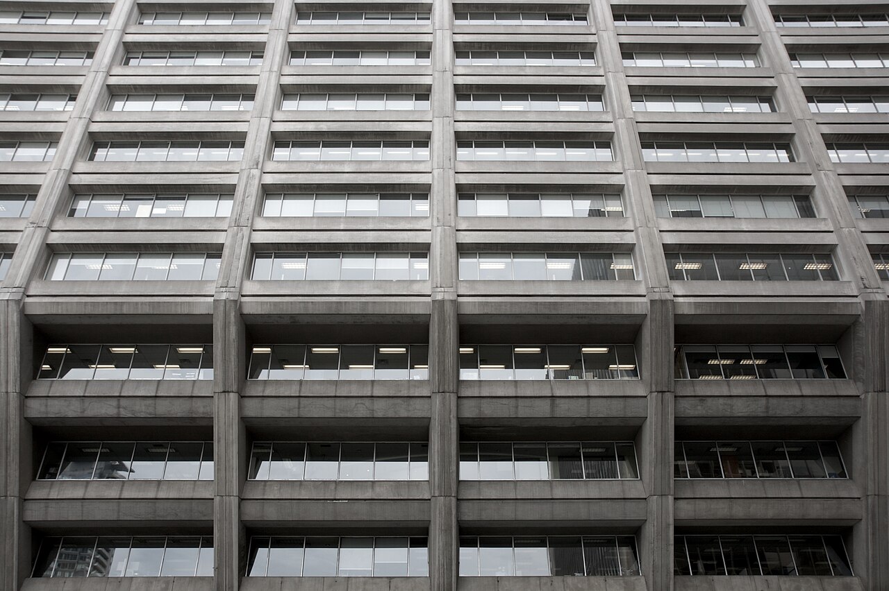Minimalist modern concrete architecture with strong structural grid geometry.